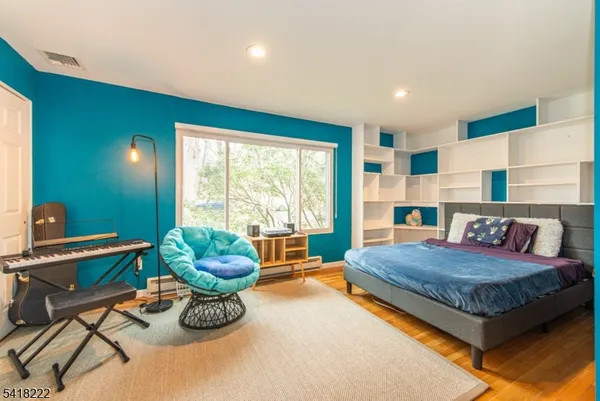 a living room with a bed furniture and a large window