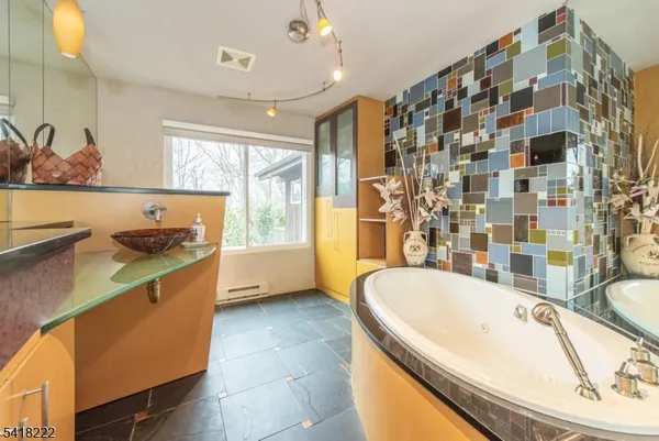 a bathroom with a bathtub and a sink