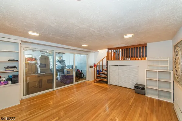 a room with wooden floor and windows