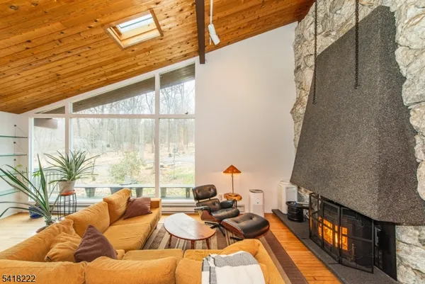 a living room with furniture and a floor to ceiling window