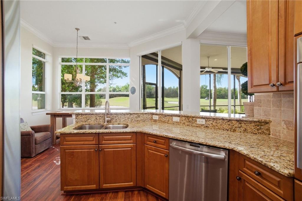 17015 Porta Vecchio Way, Unit 101 Naples, FL 34110 - Photo 10 of 39 a kitchen with stainless steel appliances granite countertop sink stove and wooden cabinets