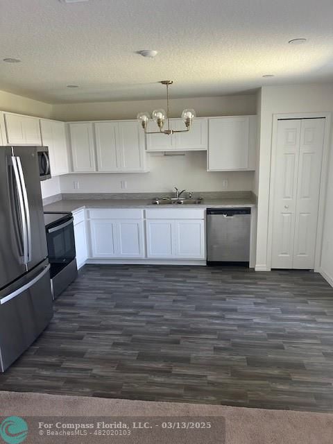 787 Southeast 25th Drive Okeechobee, FL 34974 - Photo 3 of 18 a kitchen with stainless steel appliances granite countertop a sink refrigerator and cabinets