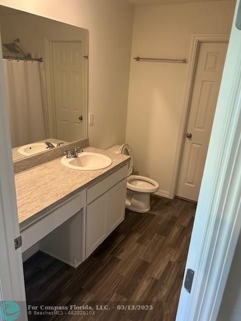 787 Southeast 25th Drive Okeechobee, FL 34974 - Photo 7 of 18 a bathroom with a granite countertop sink toilet and shower curtains