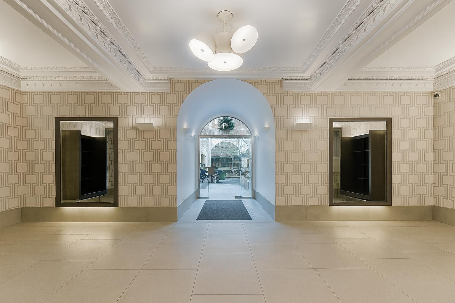 609 West 137th Street, Unit 26 Manhattan, NY 10031 - Photo 12 of 21 a view of a hallway with wooden floor and a fireplace