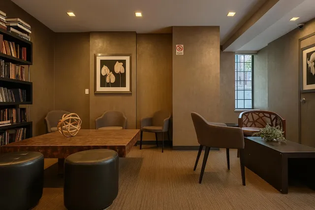 a view of a hallway with wooden floor and a fireplace