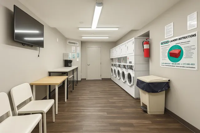 a kitchen with a sink a counter top space and living room
