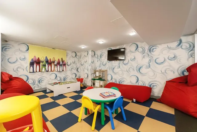 a dining room with furniture and wooden floor