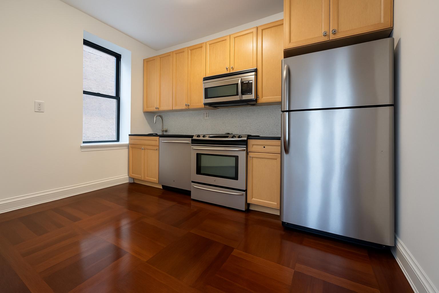 609 West 137th Street, Unit 26 Manhattan, NY 10031 - Photo 4 of 21 a kitchen with stainless steel appliances granite countertop a refrigerator microwave and sink