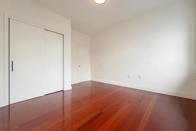 a view of a small space with wooden floor