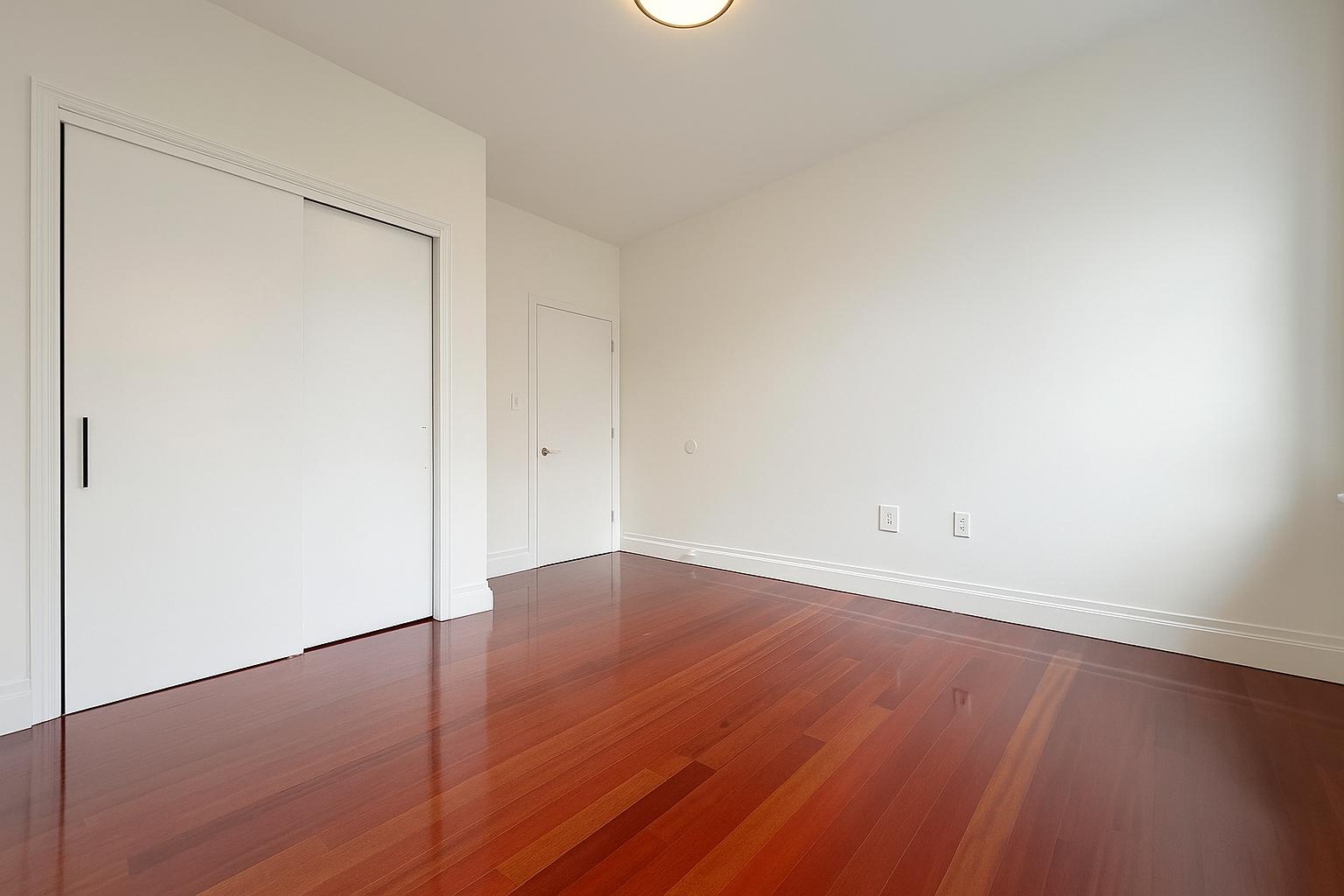 609 West 137th Street, Unit 26 Manhattan, NY 10031 - Photo 9 of 21 a view of an empty room with wooden floor
