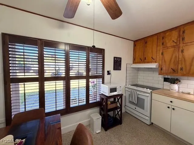 a kitchen that has a microwave and a table in it