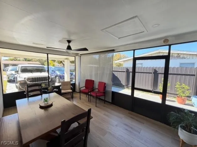 a dining room with wooden floor a glass table and chairs