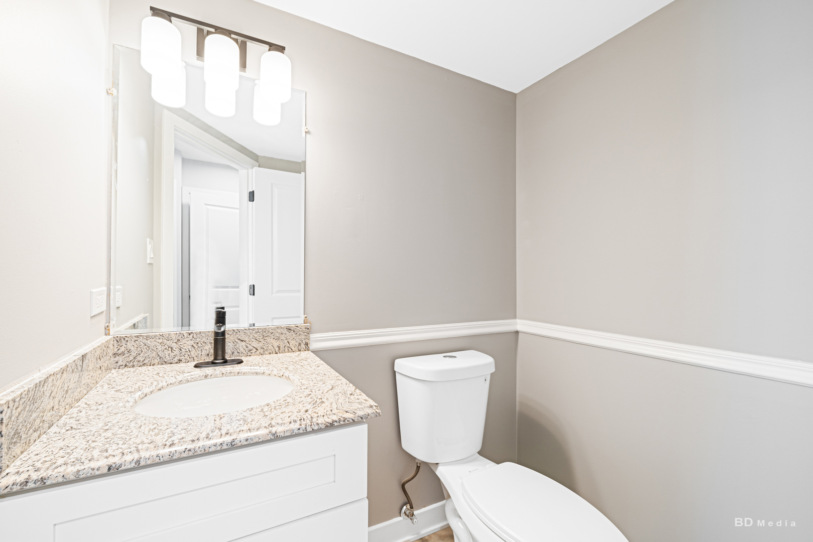7422 Terrace Drive Justice, IL 60458 - Photo 11 of 23 a bathroom with a granite countertop sink and a mirror