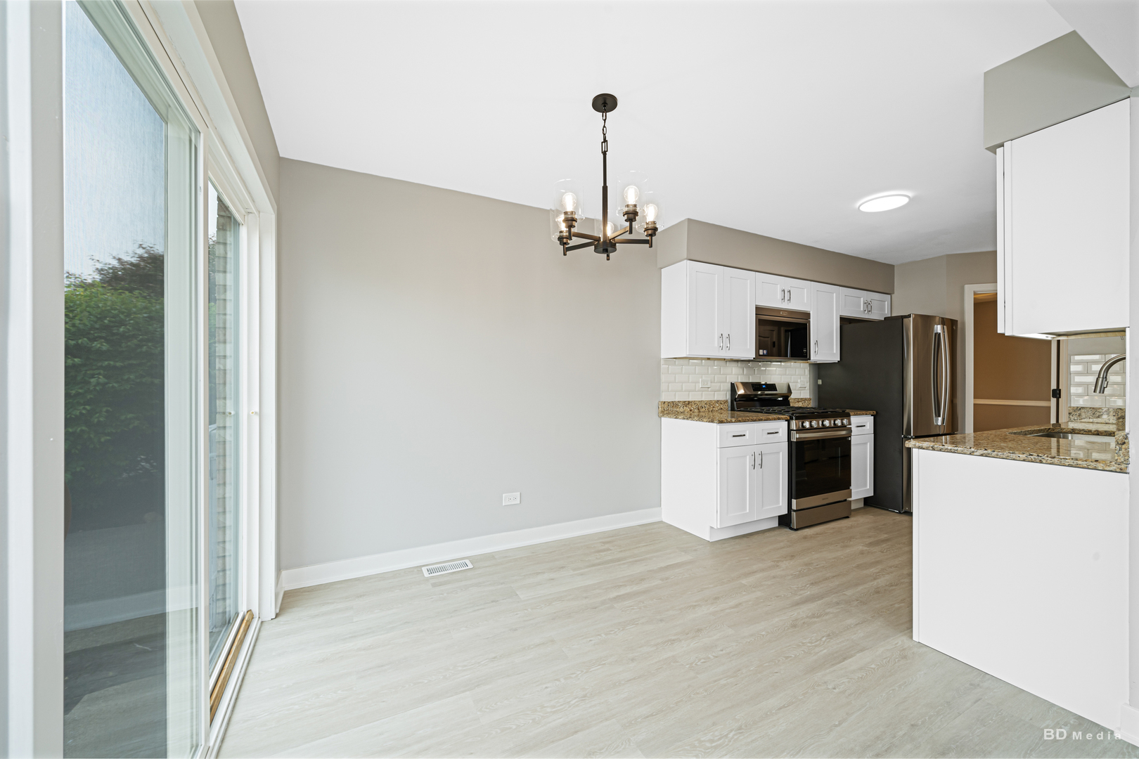 7422 Terrace Drive Justice, IL 60458 - Photo 7 of 23 a kitchen with kitchen island a counter top space a sink and stainless steel appliances