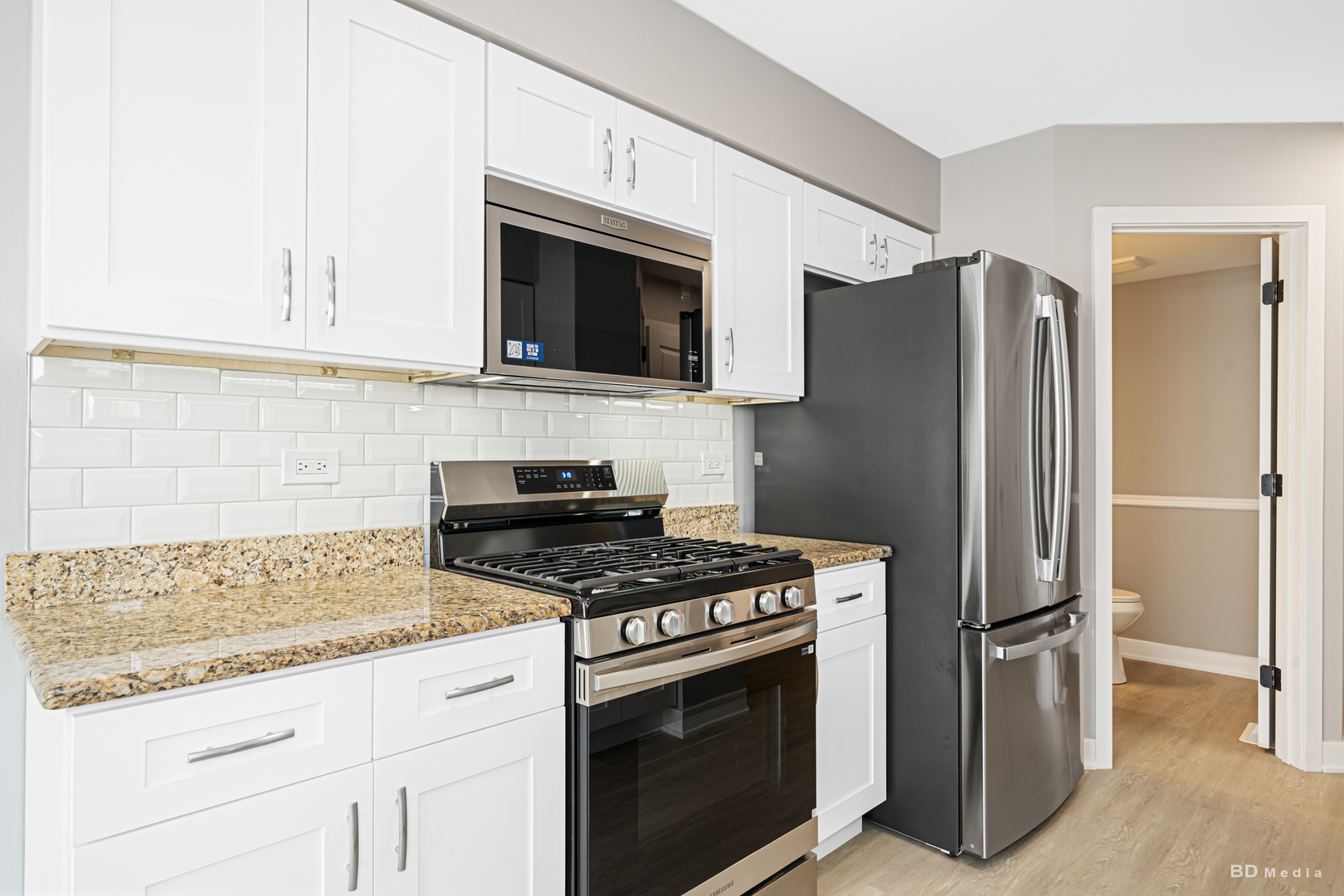7422 Terrace Drive Justice, IL 60458 - Photo 9 of 23 a kitchen with stainless steel appliances granite countertop a refrigerator stove and microwave