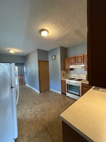 a kitchen with stainless steel appliances a refrigerator and a stove top oven