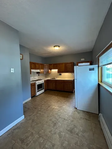 a kitchen with refrigerator and stove