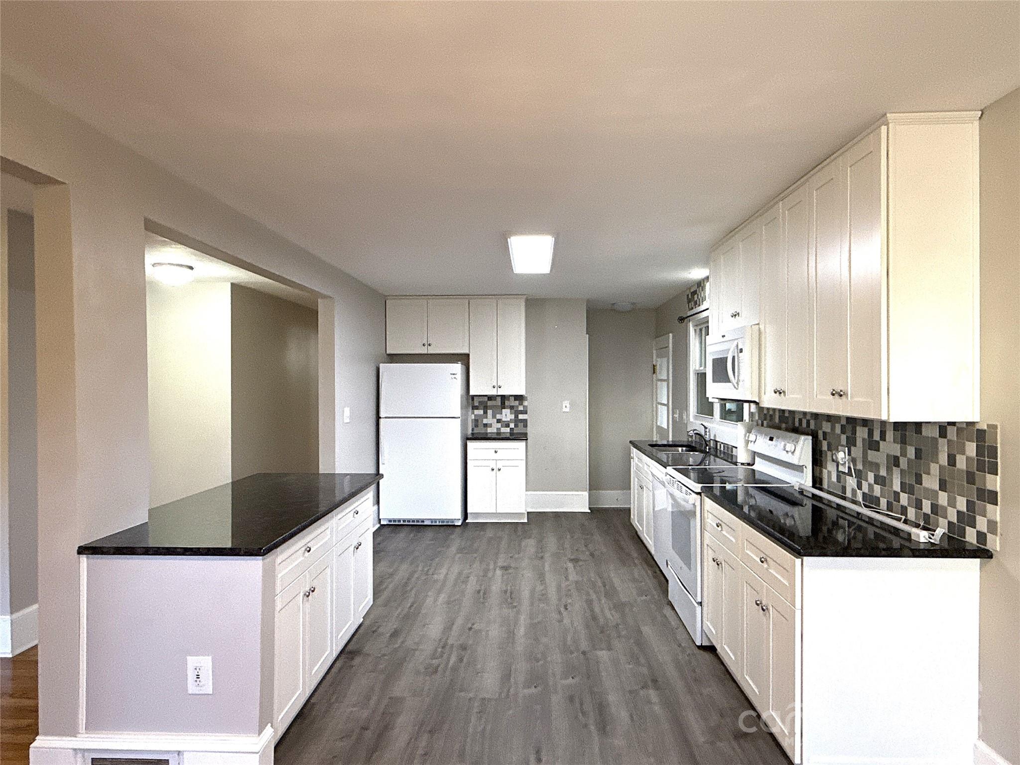 2023 Robin Road Salisbury, NC 28144 - Photo 4 of 17 a large white kitchen with granite countertop a large counter top and sink