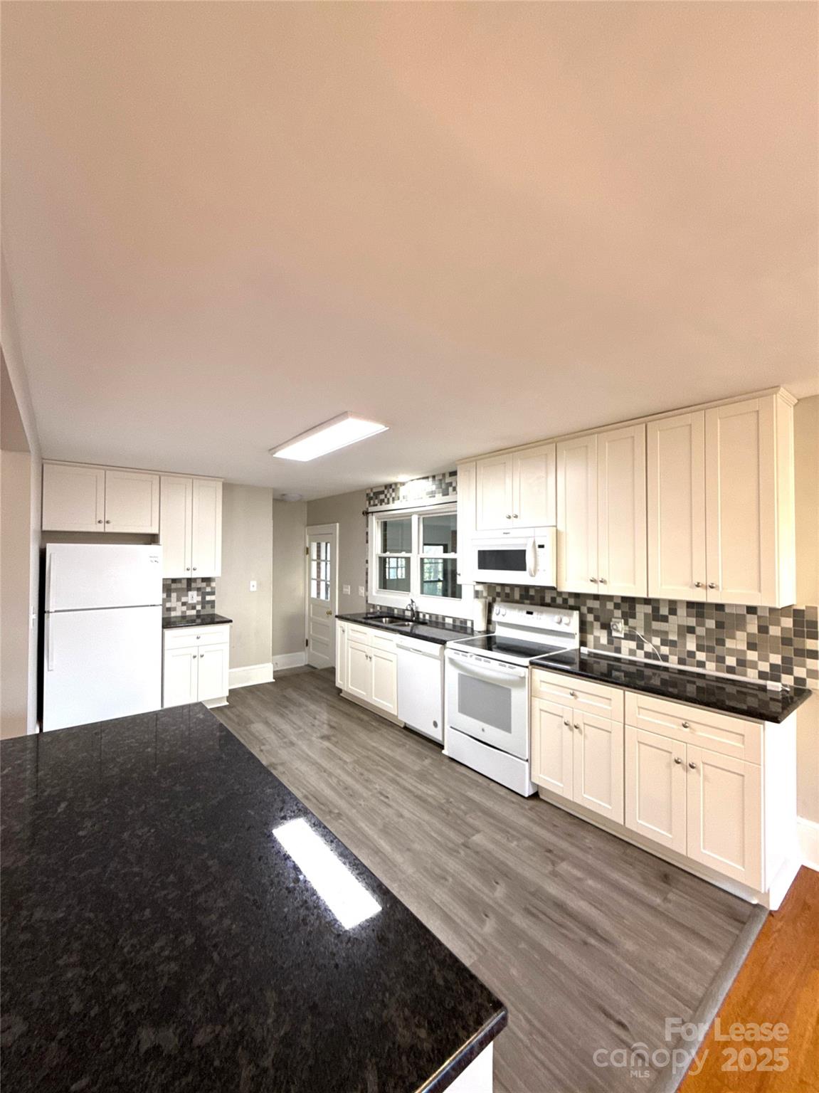 2023 Robin Road Salisbury, NC 28144 - Photo 5 of 17 a kitchen with stainless steel appliances granite countertop a stove a sink and a refrigerator