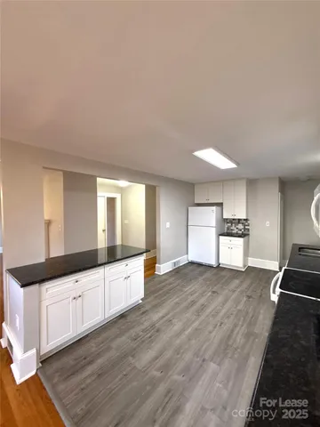 a large space with a large window and wooden floor