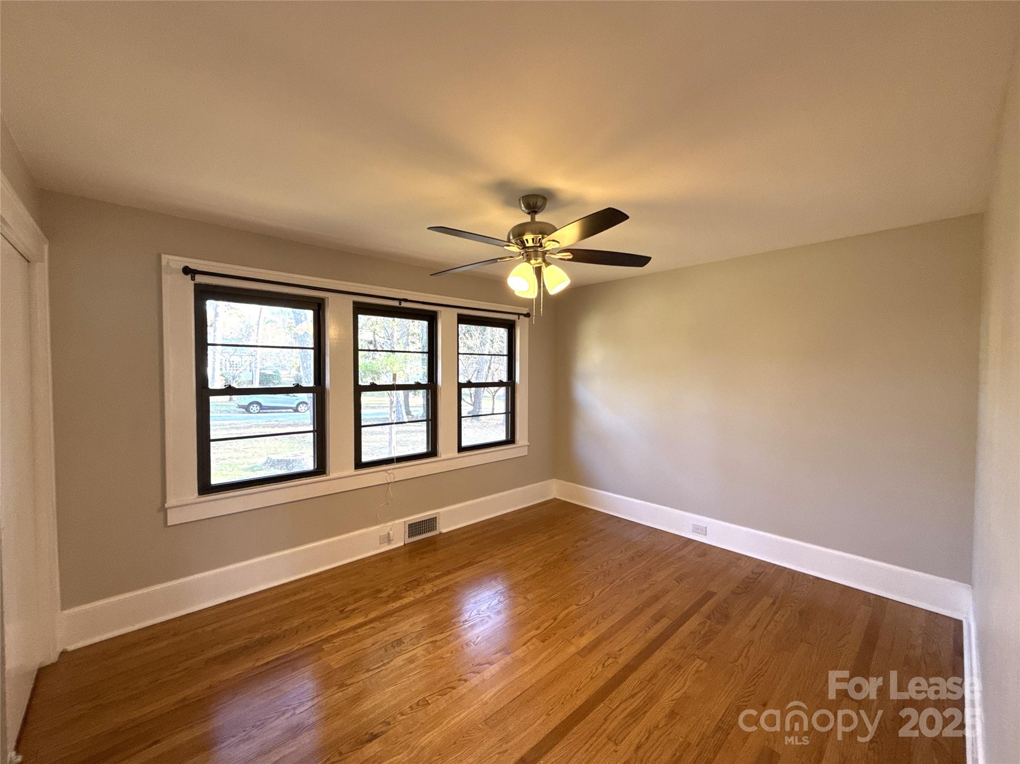 2023 Robin Road Salisbury, NC 28144 - Photo 10 of 17 a view of an empty room with a window and wooden floor