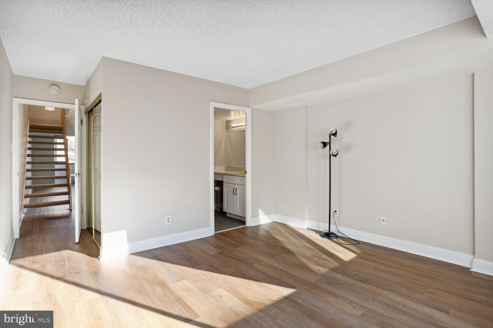 1245 13th Street Northwest, Unit 606 Washington, DC 20005 - Photo 16 of 33 a bedroom with a bed and wooden floor