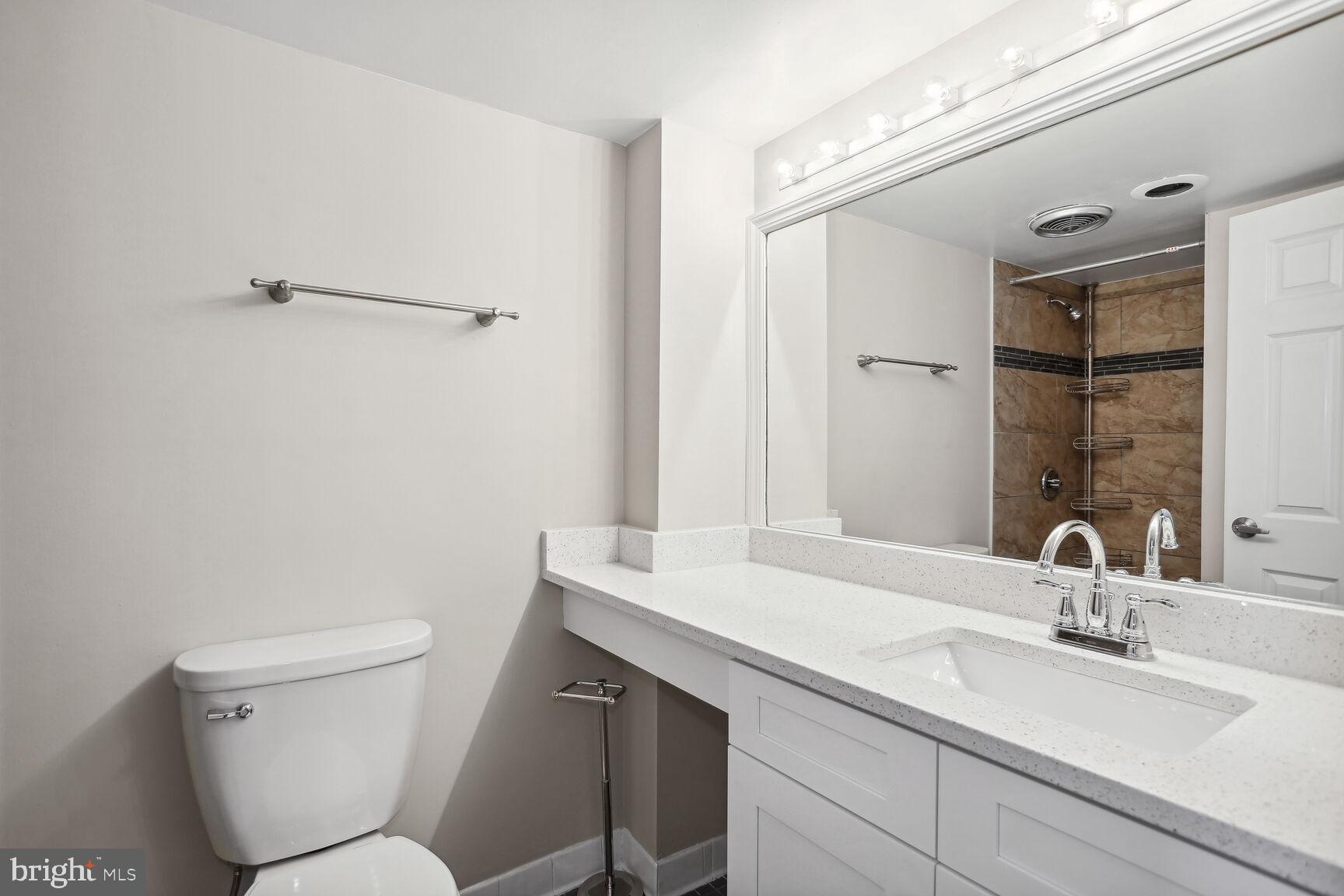 1245 13th Street Northwest, Unit 606 Washington, DC 20005 - Photo 3 of 33 a bathroom with a toilet sink and mirror