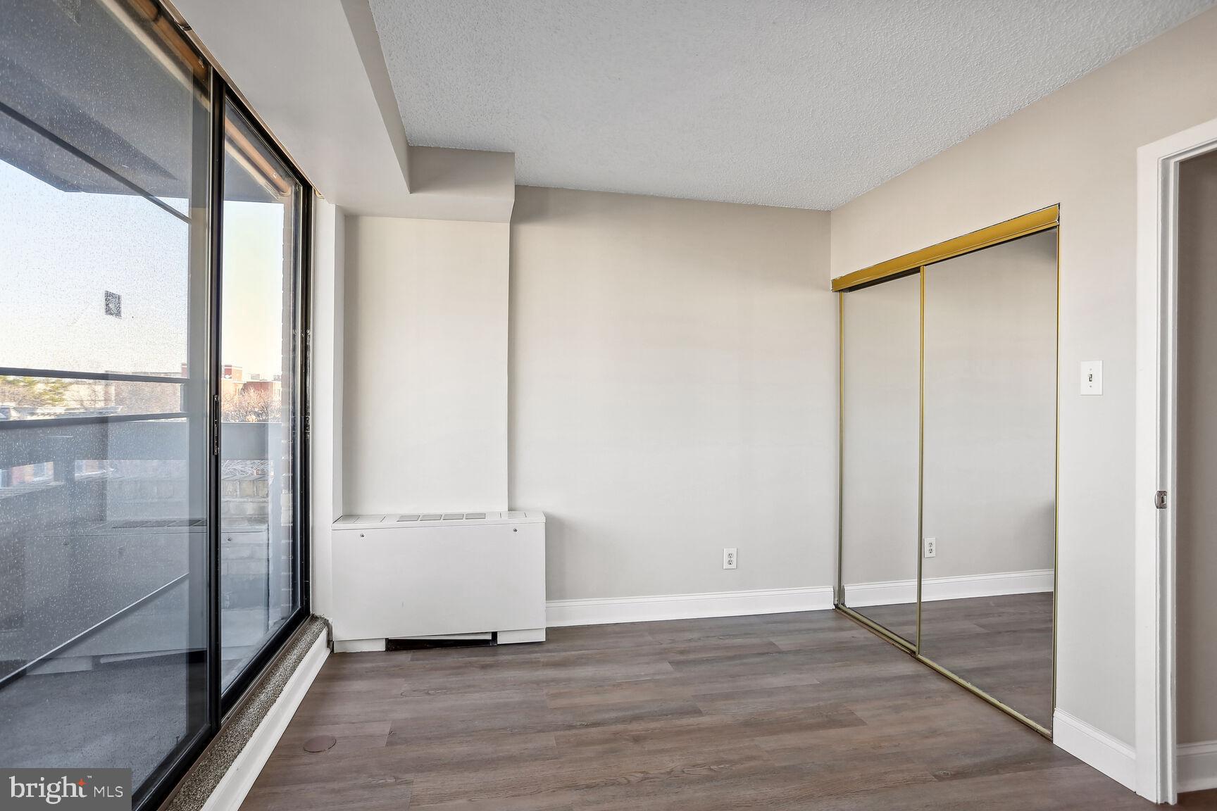 1245 13th Street Northwest, Unit 606 Washington, DC 20005 - Photo 5 of 33 a view of an empty room with wooden floor and a window