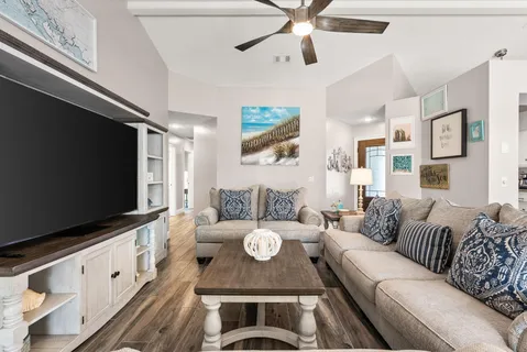 a living room with furniture and a flat screen tv