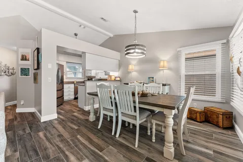 a view of a dining room with furniture window and wooden floor