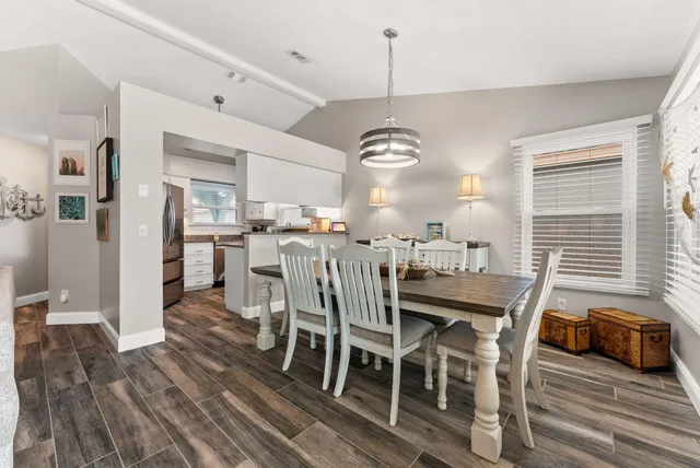 a view of a dining room with furniture window and wooden floor
