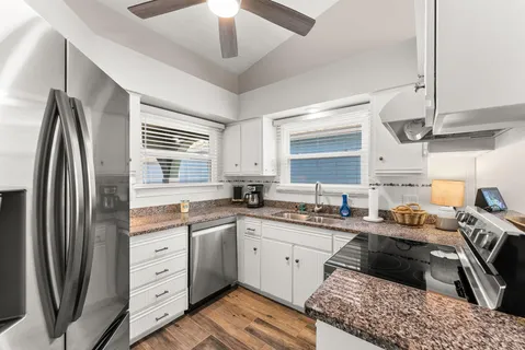 a kitchen with stainless steel appliances a sink stove and refrigerator