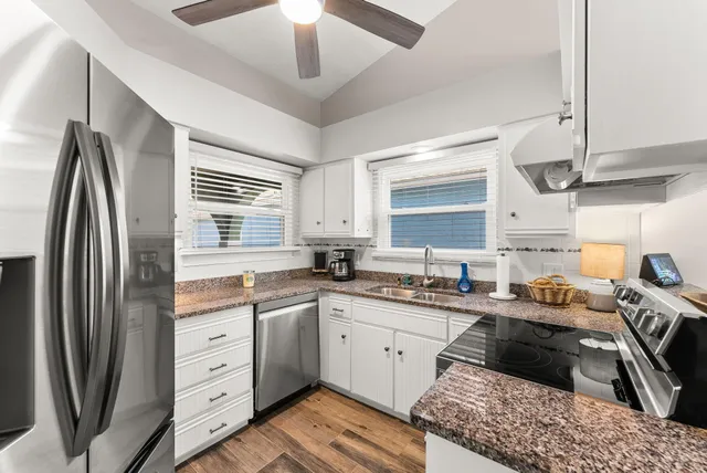 a kitchen with stainless steel appliances a sink stove and refrigerator