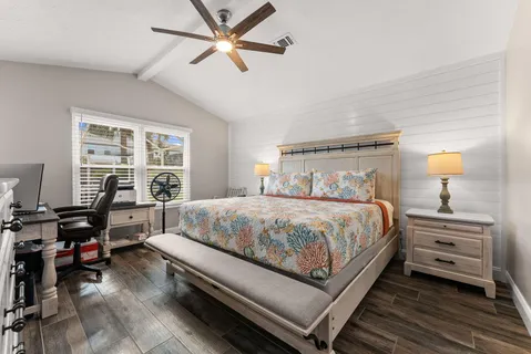 a bedroom with a bed and a window