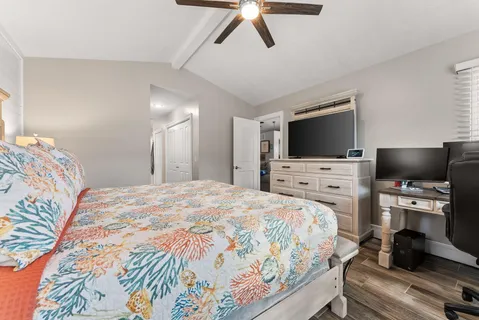 a bedroom with a bed and a flat screen tv