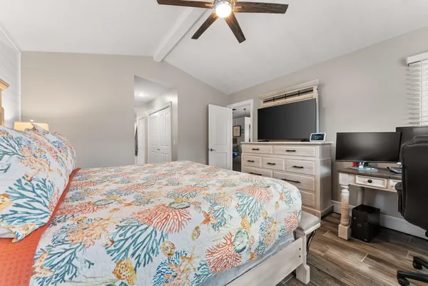 a bedroom with a bed and a flat screen tv