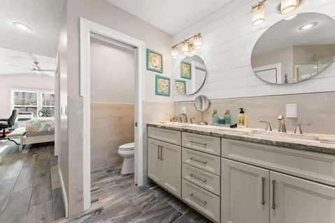 a spacious bathroom with a granite countertop sink mirror and toilet