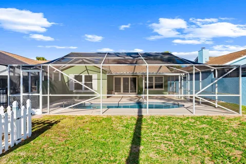 a view of a house with a backyard