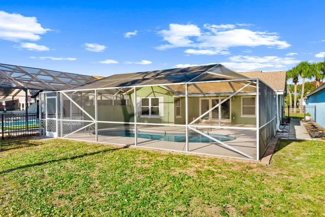 a view of a house with backyard and sitting area