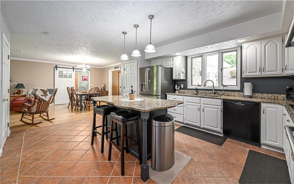 133 Miller Road Sarver, PA 16055 - Photo 4 of 50 a kitchen with stainless steel appliances a table chairs sink and cabinets
