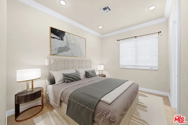 a bedroom with a bed and a lamp