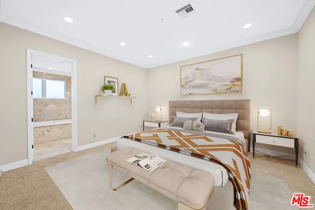 a bed room with a bed and painting on the wall