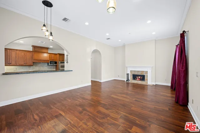 a view of a kitchen with a sink and a fireplace