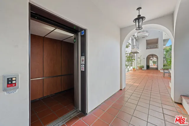 a view of a hallway with wooden shelves