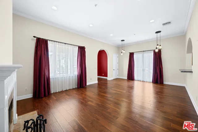 a view of a room with furniture and wooden floor