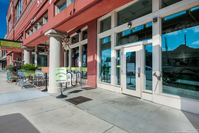 a hallway with wooden floor and chandelier