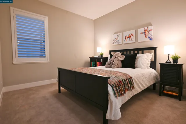 a bathroom with a tub shower and mirror