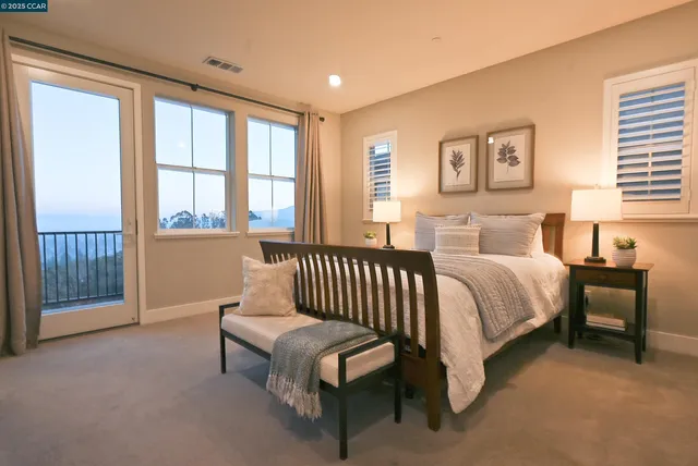 a bedroom with a large bed and a window