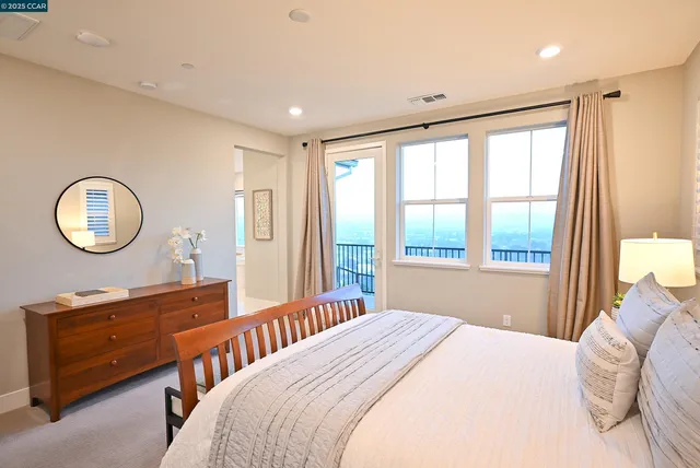 an aerial view of residential houses with cars parked