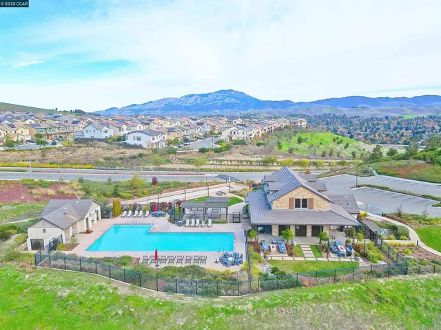 an aerial view of residential houses with outdoor space and street view